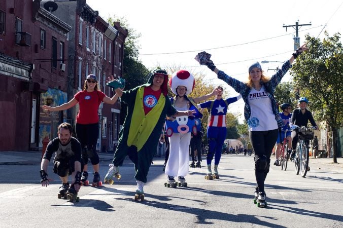 Members of Philly Roller Derby pose for photos during Philly Free Streets on N. 5th Street, Saturday, Oct. 28, 2017. (Bastiaan Slabbers for WHYY)