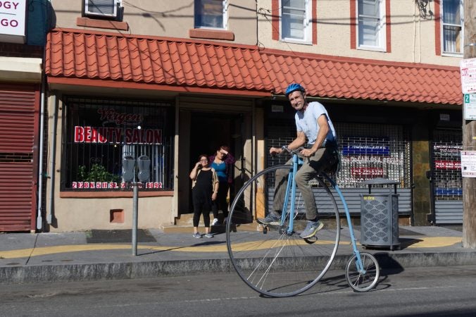 Bystanders watch as a man on a penny-farthing bike rolls past during Philly Free Streets, Saturday, Oct. 28, 2017. (Bastiaan Slabbers for WHYY)