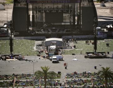 Debris is strewn through the scene of a mass shooting at a music festival near the Mandalay Bay resort and casino on the Las Vegas Strip, Monday, Oct. 2, 2017, in Las Vegas. (AP Photo/John Locher)