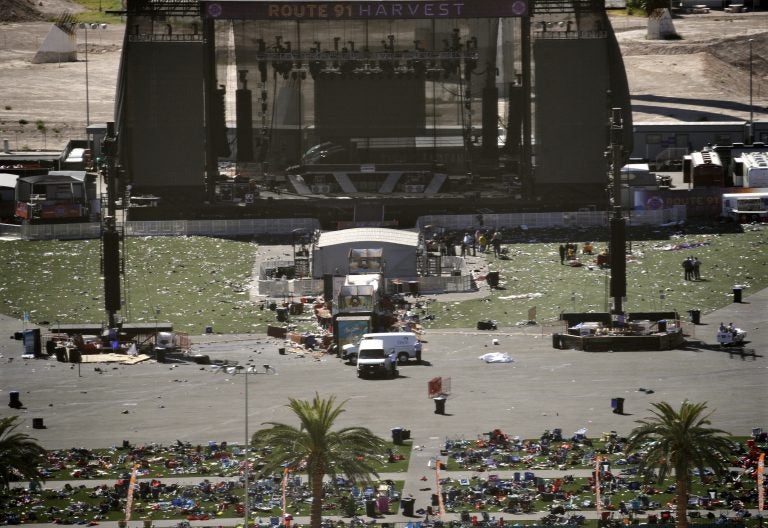 Debris is strewn through the scene of a mass shooting at a music festival near the Mandalay Bay resort and casino on the Las Vegas Strip, Monday, Oct. 2, 2017, in Las Vegas. (AP Photo/John Locher)