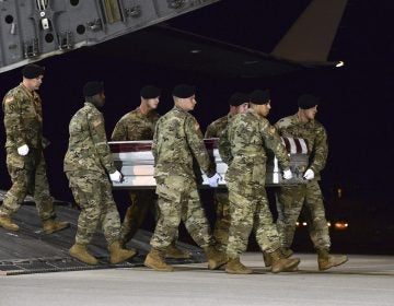 In this image provided by the U.S. Air Force, a U.S. Army carry team transfers the remains of Army Staff Sgt. Dustin Wright of Lyons, Ga., late Thursday, Oct. 5, 2017, upon arrival at Dover Air Force Base, Del. Wright, 29, of Lyons, Ga., was one of four U.S. troops and four Niger forces killed in an ambush by dozens of Islamic extremists on a joint patrol of American and Niger Force.