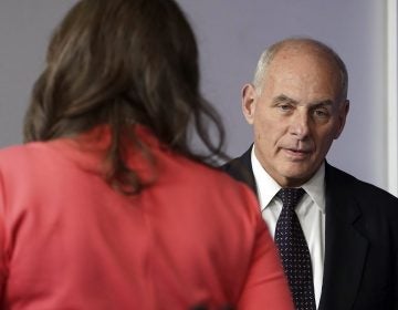 White House Chief of Staff John Kelly walks past White House press secretary Sarah Huckabee Sanders to begin speaking to the media during the daily briefing in the Brady Press Briefing Room of the White House, Thursday, Oct. 19, 2017.