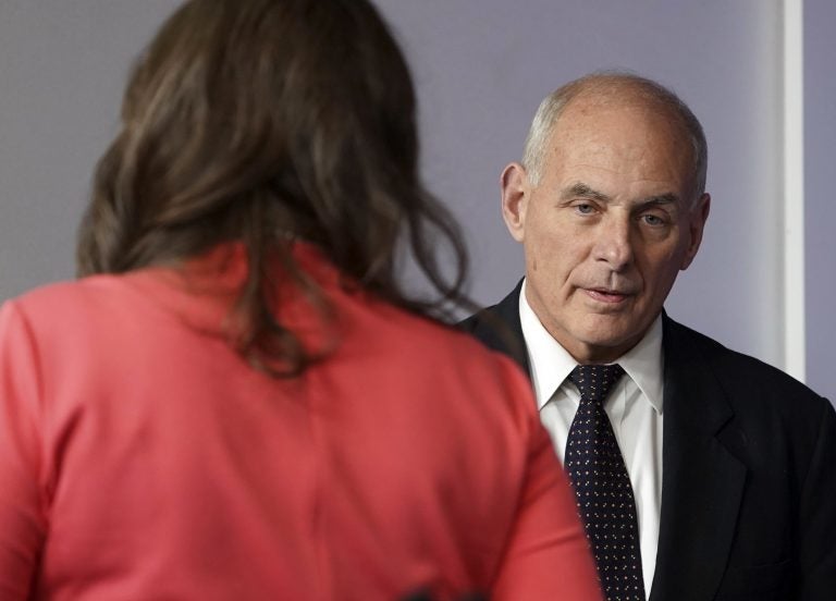 White House Chief of Staff John Kelly walks past White House press secretary Sarah Huckabee Sanders to begin speaking to the media during the daily briefing in the Brady Press Briefing Room of the White House, Thursday, Oct. 19, 2017.