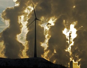 In 2010 file photo, a wind turbine is pictured in the in front of a steaming coal power plant in Gelsenkirchen, Germany.