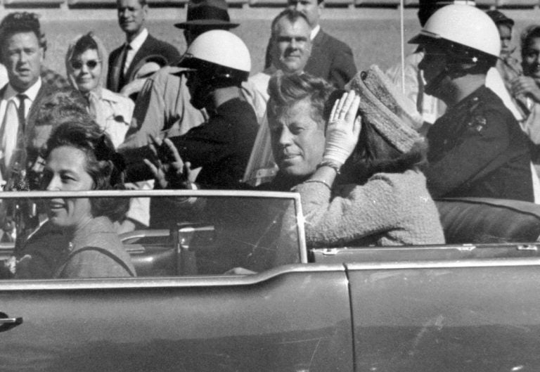 John F. Kennedy, Jacqueline Kennedy, John Connally, Nellie Connally Black and white photo of Mr. and Mrs. JFK in the limousine, moments before the assassination