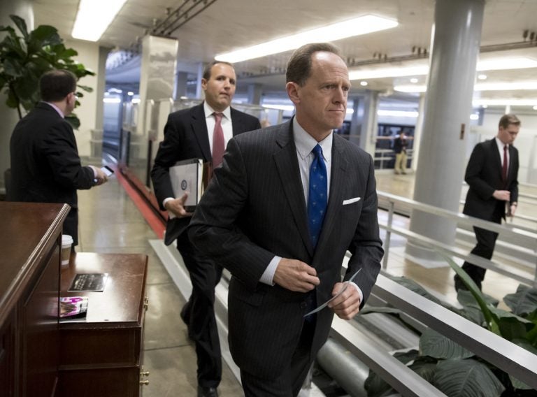 Toomey walks through a hallway in the Capitol