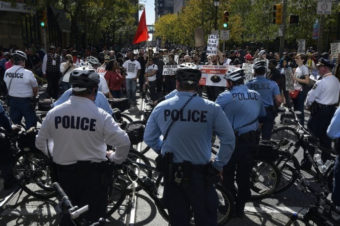 Officers can be seen from behind as protesters approach