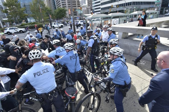 Officers push against a group of protesters