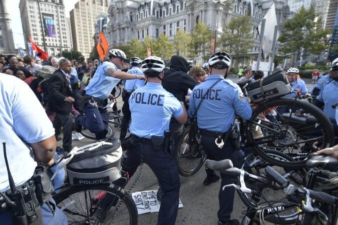 Officers push against a group of protesters