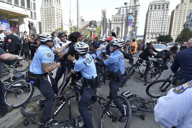 Officers push against a group of protesters