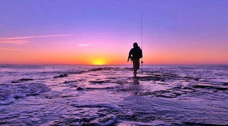 An angler walks a jetty in Asbury Park. (Photo: Suzanne Spitaletta)