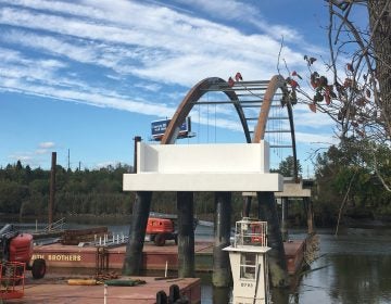 Workers have installed the arch supports for the longest bike bridge ever built in Delaware across the Christina River. (Mark Eichmann/WHYY)