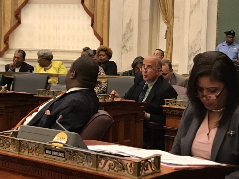 Philadelphia Councilman Mark Squilla (second from right) speaks with a colleague at a City Council session Thursday. (Joel Wolfram/for WHYY)