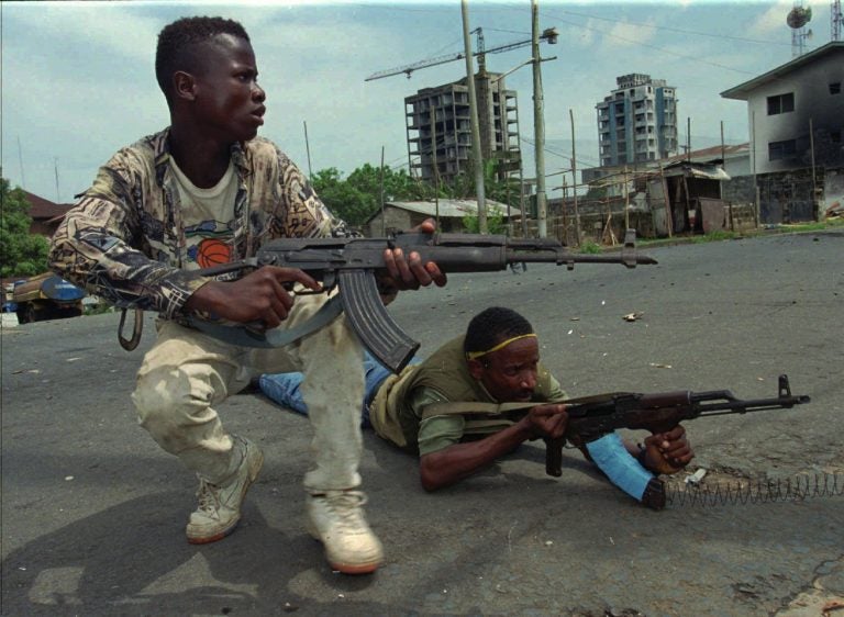 Fighters from the United Liberation Movement of Liberia (ULIMO) shoot their way through downtown Monrovia, LIberia Tuesday, April 16, 1996.