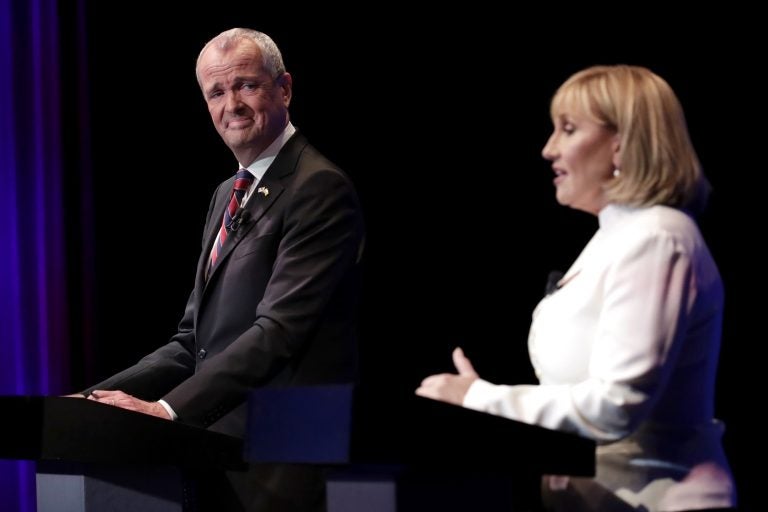 Democratic nominee Phil Murphy (left) listens as Republican nominee Lt. Gov. Kim Guadagno (right) answers a question during a gubernatorial debate at the New Jersey Performing Arts Center, Tuesday, Oct. 10, 2017, in Newark, N.J.