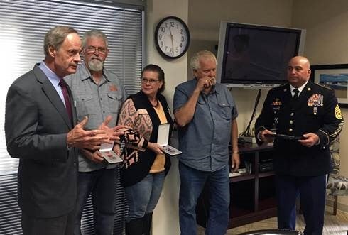 U.S. Senator Tom Carper, D-Del, presented the family of the late Private First Class James Davis, Jr. with the Bronze Star and Purple Heart Medals for Davis’ service in the Army. From left: Senator Carper, James Davis, IV, Tina Davis, James Davis, III, and Command Sergeant Major Donald Catalon.  (Provided)