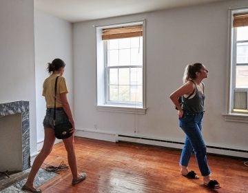 Prospective renters Lisa Schaufler (left) and Alyssa Koenigsberg tour a brownstone in Society Hill. (Natalie Piserchio for WHYY)