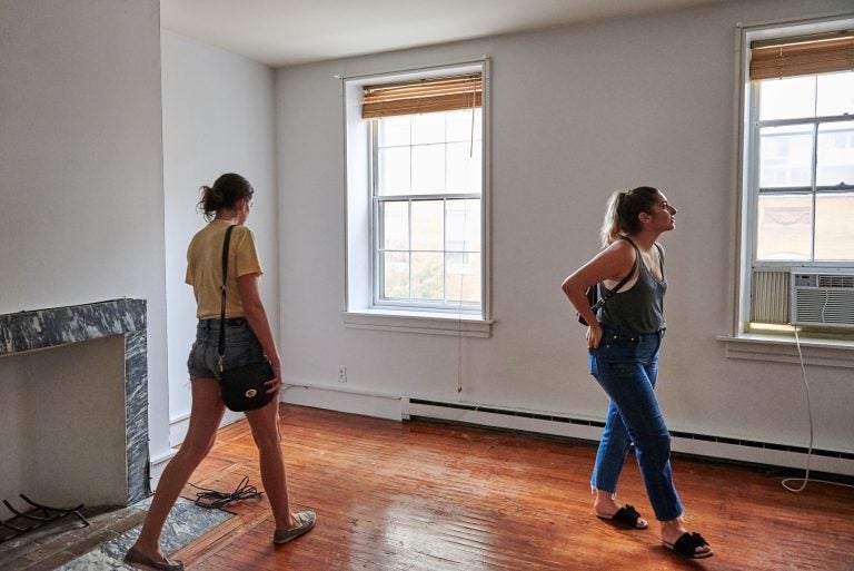 Prospective renters Lisa Schaufler (left) and Alyssa Koenigsberg tour a brownstone in Society Hill. (Natalie Piserchio for WHYY)