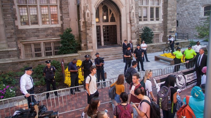 People mill around at a protest