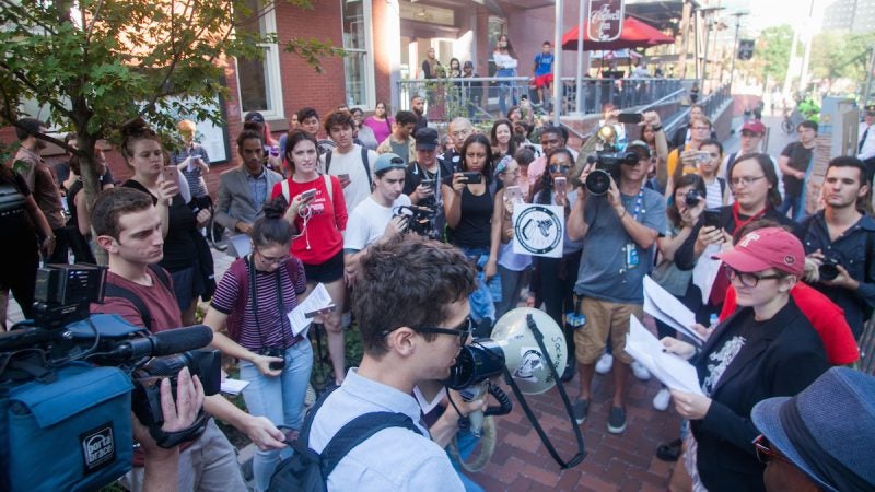 Protesters gather, more closely during a rally to oppose a potential stadium