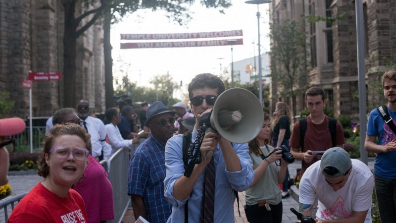 A man with a megaphone during a protest at Temple University