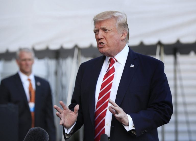 President Trump speaks to reporters Saturday at Andrews Air Force Base in Maryland. The Trump administration sent a list of immigration policy priorities to Congress that includes overhauling the country's green-card system, hiring 10,000 more immigration officers and building a wall along the southern border. (Manuel Balce Ceneta/AP)