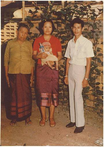 The author is shown as an infant, shortly after she was born in the Nongkhai Refugee Camp in Thailand. 