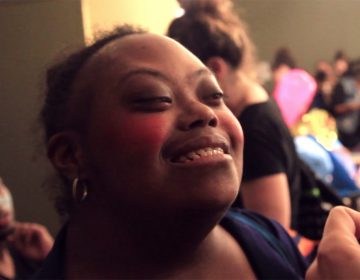 A participant of the SpArc Services Cultural Arts Center has her make-up done for a 2017 Fringe Festival production, 