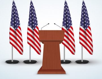 Wooden Podium Speaker Tribune with United States flags on background.