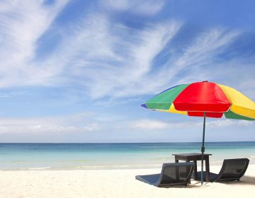 umbrella and chairs on white sand beach (volare2004/BigStock)