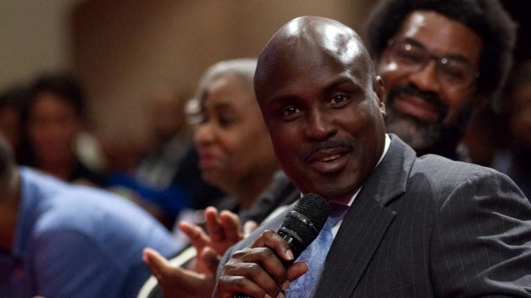 Solomon Jones, co-moderator, seated with a sub-panel, during Courageous Conversations: Reimagining Race and Education forum at Enon Tabernacle Church, on Thursday night. (Bastiaan Slabbers for WHYY)