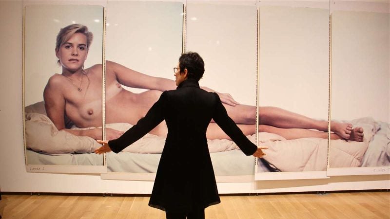 Curator Terrie Sultan stands before Chuck Close's ''Laura I,'' 1984.