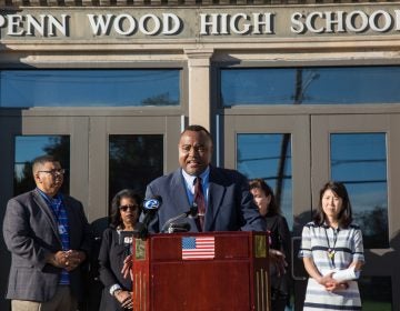 A man at a podium outside the Penn Wood High School