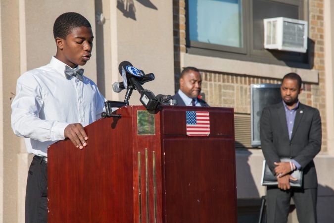 A boy speaks at a podium