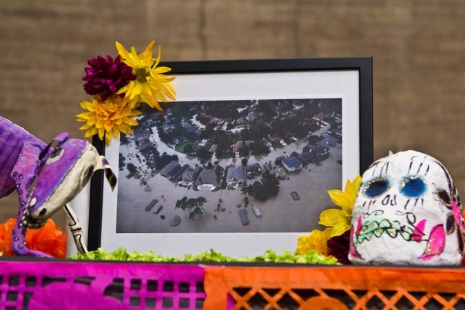 An image from Hurricane Harvey’s flooding is displayed on the 2017 Day of the Dead Altar at the Penn Museum. (Kimberly Paynter/WHYY)