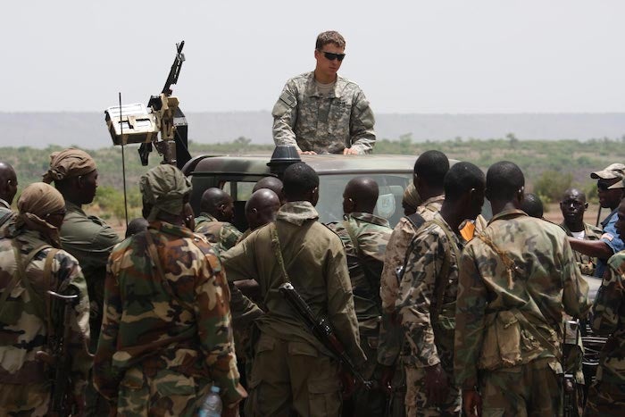 Malian special forces listen to instructions from a US Special Forces soldier on counter-ambush tactics in Kita, Mali, during a joint training exercise. (AP Photo / Alfred de Montesquiou)