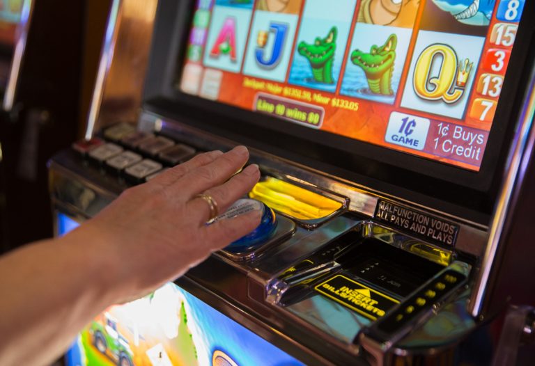A woman plays the slots at Hollywood Casino at Penn National Race Course in Dauphin County, Pennylvania. (Lindsay Lazarski/WHYY)