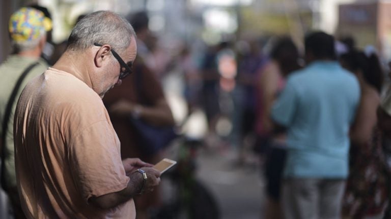 A man stands at a Wi-Fi hotspot in the aftermath of Hurricane Maria with many cellphone towers down in San Juan, Puerto Rico, Sunday, Sept. 24, 2017. (Carlos Giusti/AP Photo)