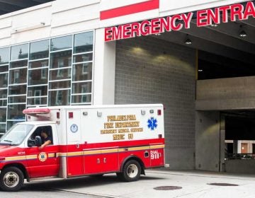 An ambulance pulls out of the emergency entrance at Temple University Hospital.