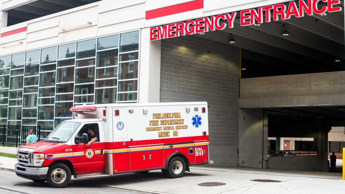 An ambulance pulls out of the emergency entrance at Temple University Hospital.