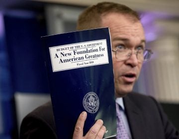 Budget Director Mick Mulvaney holds up a copy of President Donald Trump's proposed fiscal 2018 federal budget. His $4.1 trillion plan for the budget year beginning Oct. 1 generally proposes deep cuts in safety net programs, including Medicaid and the Children's Health Insurance Program.