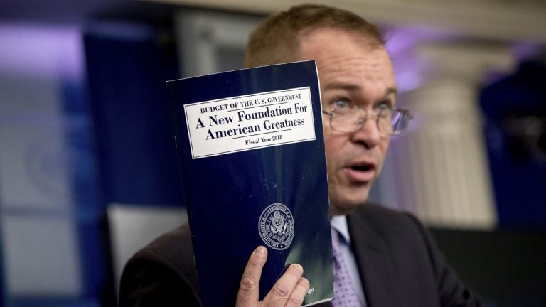 Budget Director Mick Mulvaney holds up a copy of President Donald Trump's proposed fiscal 2018 federal budget. His $4.1 trillion plan for the budget year beginning Oct. 1 generally proposes deep cuts in safety net programs, including Medicaid and the Children's Health Insurance Program.