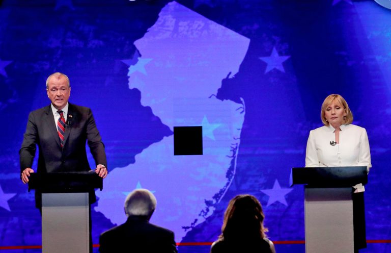 Democratic nominee Phil Murphy, left, and Republican nominee Lt. Gov. Kim Guadagno, right, participates in a gubernatorial debate at the New Jersey Performing Arts Center, Tuesday, Oct. 10, 2017, in Newark, N.J. (AP Photo/Julio Cortez, Pool)