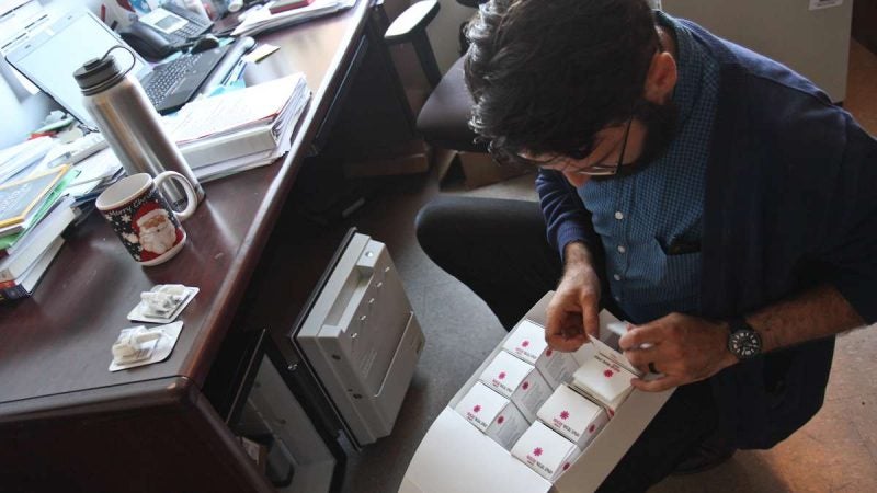 Matt Tice, Director of clinical services at Pathways to Housing, retrieves Narcan from a safe in his office. (Kimberly Paynter/WHYY)