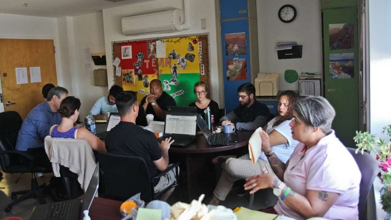 The Pathways to Housing team discusses the needs of clients at their morning meeting. (Kimberly Paynter/WHYY)