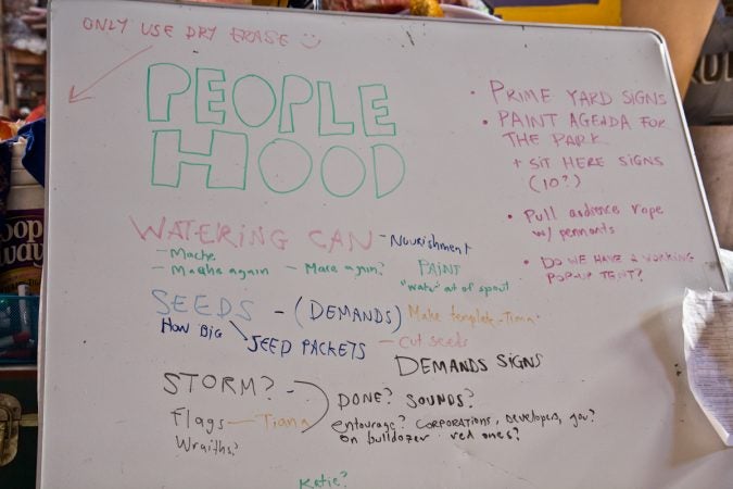 Volunteers and staff prepare for the 18th Peoplehood Parade at the Spiral Q warehouse. (Kimberly Paynter/WHYY)