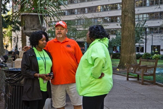 Ashley Cotton (left), Wes Lilly (center) and Sherika Morgan (right), reach out to the homeless in Rittenhouse Square Park.