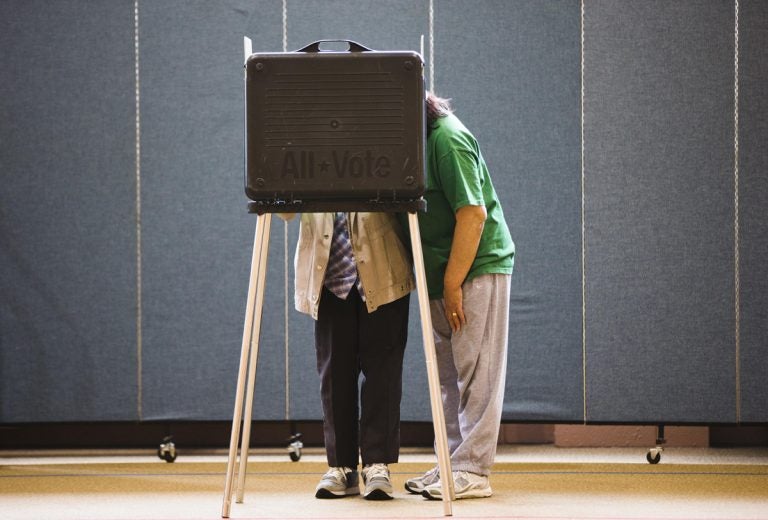 A woman assists her mother filling out her ballot in a church polling place in Lancaster, Pa. (AP File Photo/Matt Rourke)