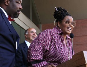 Jill Scott, a Philadelphia native and a three-time Grammy Award-winning singer-songwriter, is honored with a plaque on the Philadelphia Music Walk of Fame during a ceremony outside the Kimmel Center. (Emma Lee/WHYY)