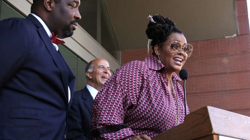 Jill Scott, a Philadelphia native and a three-time Grammy Award-winning singer-songwriter, is honored with a plaque on the Philadelphia Music Walk of Fame during a ceremony outside the Kimmel Center. (Emma Lee/WHYY)